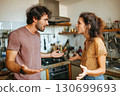 married couple is quarreling in the kitchen. Husband and wife are screaming in the home. Family conflict and disagreements 130699693