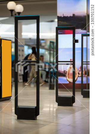 Radio-frequency security gates with integrated metal detector at a clothing store entrance 130701152