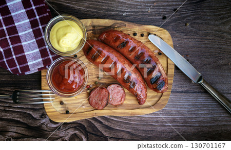 Delicious roasted wurst sausages on wooden table Delicious roasted wurst sausages on wooden table 130701167