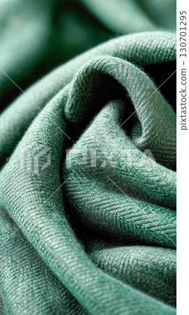 Close-up of soft green fabric showcasing intricate texture and folds, highlighting the beauty of textile design and craftsmanship in fashion 130701295