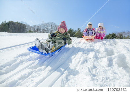 Children playing in the snow in the winter park Children playing in the snow in the winter park 130702281