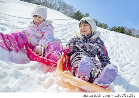 Children playing in the snow in the winter park 130702283