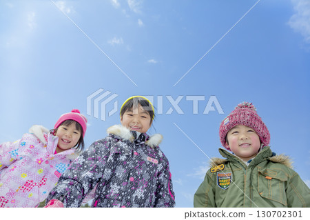 Children playing in the snow in the winter park 130702301