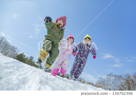 Children playing in the snow in the winter park Children playing in the snow in the winter park 130702306