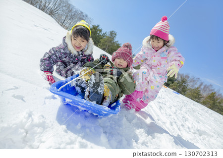 Children playing in the snow in the winter park 130702313