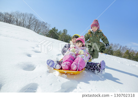Children playing in the snow in the winter park Children playing in the snow in the winter park 130702318