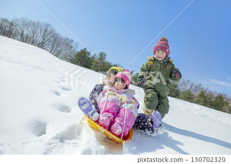 Children playing in the snow in the winter park 130702320