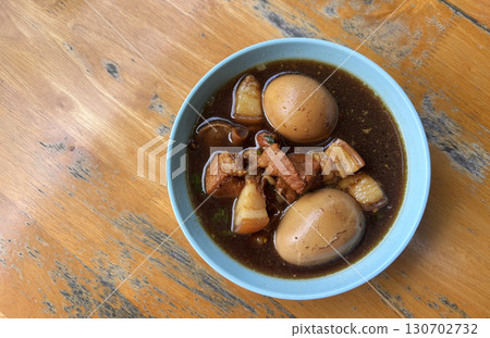 Top view Boiled Eggs in Sweet Brown Soup or Five-Spice Egg in a small bowl with natural light, or called  Kai Paloh in Thai language. One of healthy Asian food. 130702732