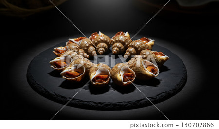 Artistic Display of Whelks on Black Plate 130702866