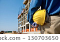 Industrial construction worker holding helmet safety gear Industrial construction worker holding helmet safety gear 130703650