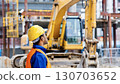 Construction site worker operating heavy equipment safely Construction site worker operating heavy equipment safely 130703652