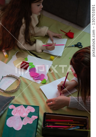 A mother and daughter spend quality time together creating handmade cards and crafts. A mother and daughter spend quality time together creating handmade cards and crafts. 130703891