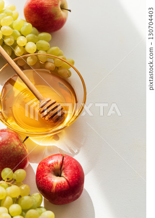 Honey Bowl with Apples and Grapes on Light Background 130704403