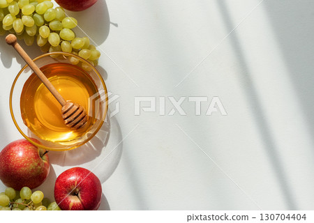 Honey Bowl with Apples and Grapes on Light Background 130704404