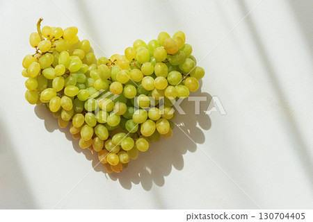 Heart-Shaped Green Grapes on White Background with Shadows Heart-Shaped Green Grapes on White Background with Shadows 130704405