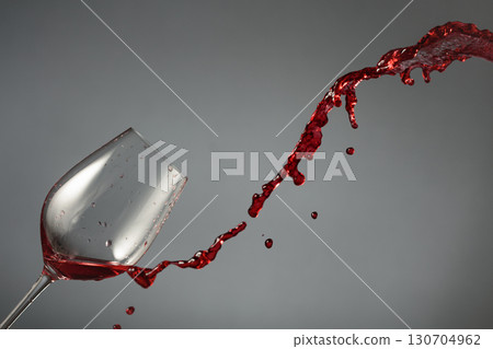 Glass and red wine splash on a dark background. 130704962