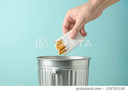 throws a pack of cigarettes into the garbage bin 130705188