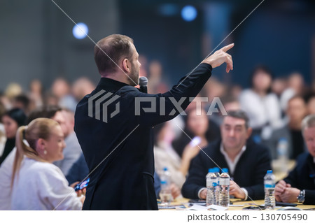 Businessman speaking to an audience at a professional seminar or conference 130705490
