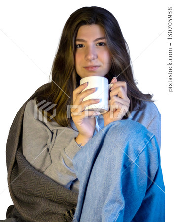Beautiful teenager in an everyday winter scene, drinking a hot beverage. Beautiful teenager in an everyday winter scene, drinking a hot beverage. 130705938
