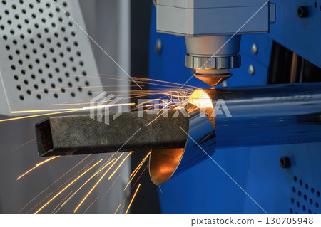 Close up scene the fiber laser cutting machine cut the stainless steel tube with sparkling light. Close up scene the fiber laser cutting machine cut the stainless steel tube with sparkling light. 130705948