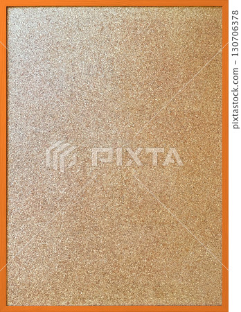 A vertical background image of a cork board with a thin orange wooden frame 130706378