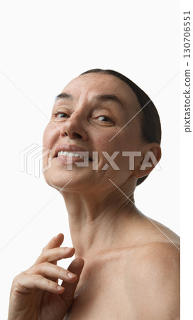 Mature woman looking upward with hopeful face expression 130706551