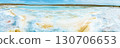 Salt lake with white mineral crystals and turquoise water against hills and sky 130706653