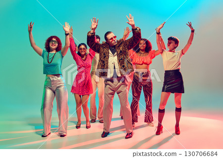 Group of stylish dancers raising hands in retro disco atmosphere 130706684