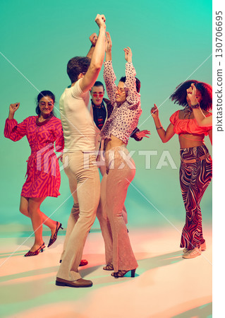 Retro style man and woman dancing together in colorful studio. 130706695