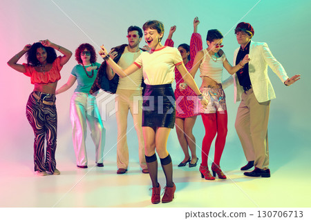 Energetic woman leading retro dance group with joyful expression Energetic woman leading retro dance group with joyful expression 130706713