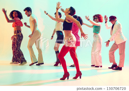 Retro styled group dancing with joyful energy under colorful lights Retro styled group dancing with joyful energy under colorful lights 130706720