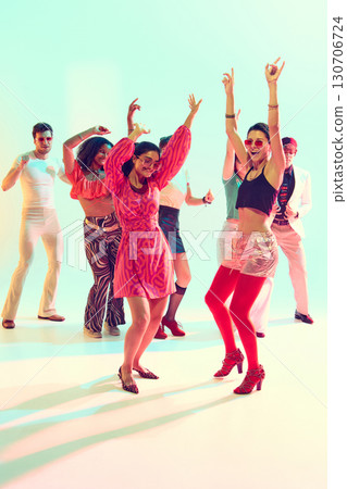 Women in bright outfits dancing with excitement at retro themed party Women in bright outfits dancing with excitement at retro themed party 130706724