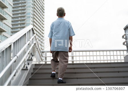 Elderly man climbing the stairs 130706807