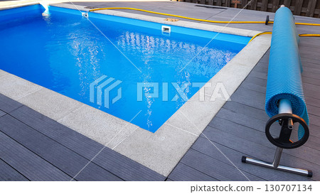 Swimming pool cover for protection against dirt, leaves, heating and cooling water, copy space 130707134