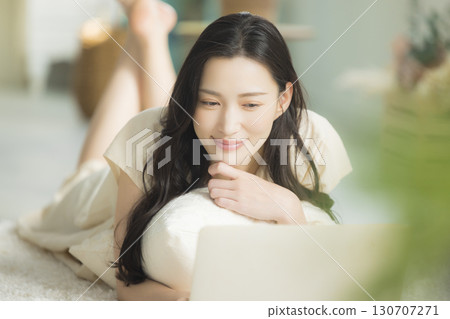 Woman lying on the sofa in the living room 130707271