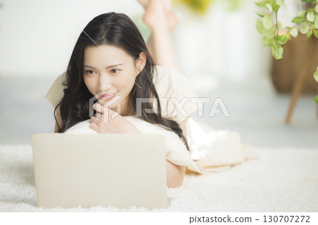 Woman lying on the sofa in the living room Woman lying on the sofa in the living room 130707272