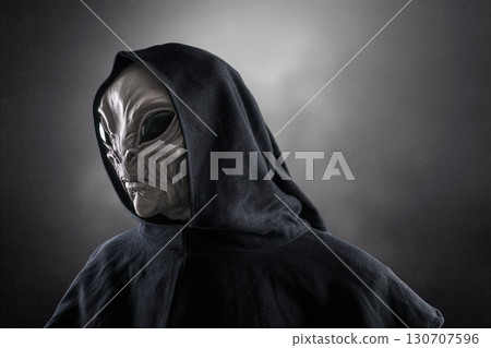 Mysterious humanoid alien at night over dark misty background  Mysterious humanoid alien at night over dark misty background  130707596