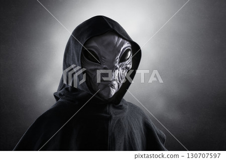 Mysterious humanoid alien at night over dark misty background  130707597