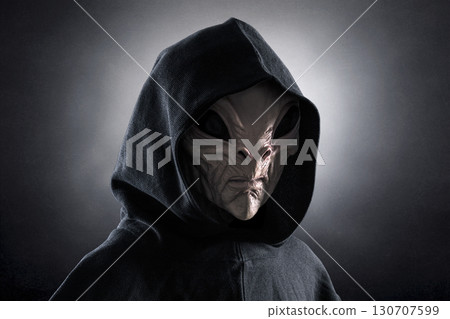Mysterious humanoid alien at night over dark misty background  130707599