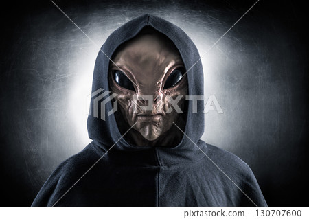 Mysterious humanoid alien at night over dark misty background  130707600