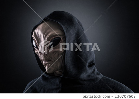 Mysterious humanoid alien at night over dark misty background  Mysterious humanoid alien at night over dark misty background  130707602