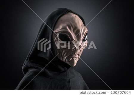 Mysterious humanoid alien at night over dark misty background  Mysterious humanoid alien at night over dark misty background  130707604