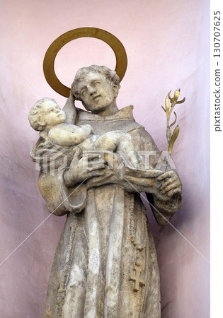 Saint Anthony of Padua holding baby Jesus, statue on the facade of the Saint Francis church in Budapest, Hungary Saint Anthony of Padua holding baby Jesus, statue on the facade of the Saint Francis church in Budapest, Hungary 130707625