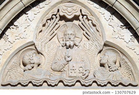 Relief of Jesus the Pantocrator from side portal of church of St. Matthias near the fisherman bastion in Budapest, Hungary 130707629