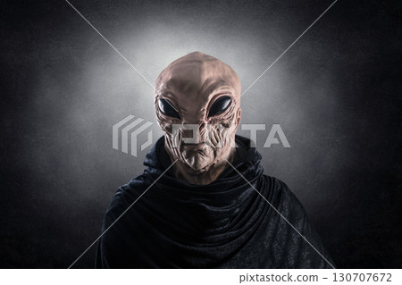 Mysterious humanoid alien at night over dark misty background  Mysterious humanoid alien at night over dark misty background  130707672