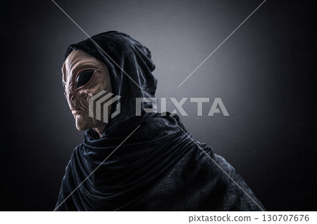 Mysterious humanoid alien at night over dark misty background  Mysterious humanoid alien at night over dark misty background  130707676