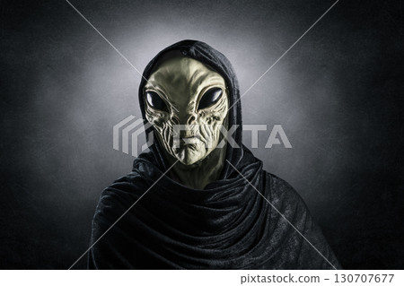 Mysterious humanoid alien at night over dark misty background  130707677