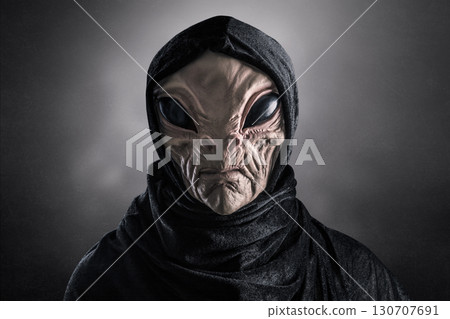 Mysterious humanoid alien at night over dark misty background  130707691