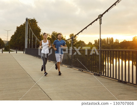Couple jogging in the park having sport workout in nature together. Healthy lifestyle concept. 130707808