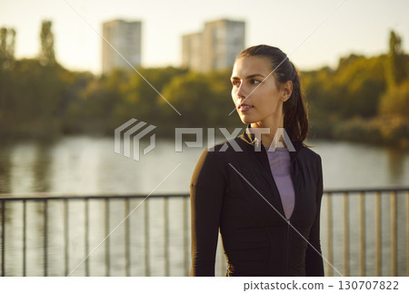 Blurred background of lush greenery and lake woman standing enjoys tranquility of nature city park. Idyllic scene captures essence of city park peaceful retreat amidst bustling city life Green park. Blurred background of lush greenery and lake woman standing enjoys tranquility of nature city park. Idyllic scene captures essence of city park peaceful retreat amidst bustling city life Green park. 130707822